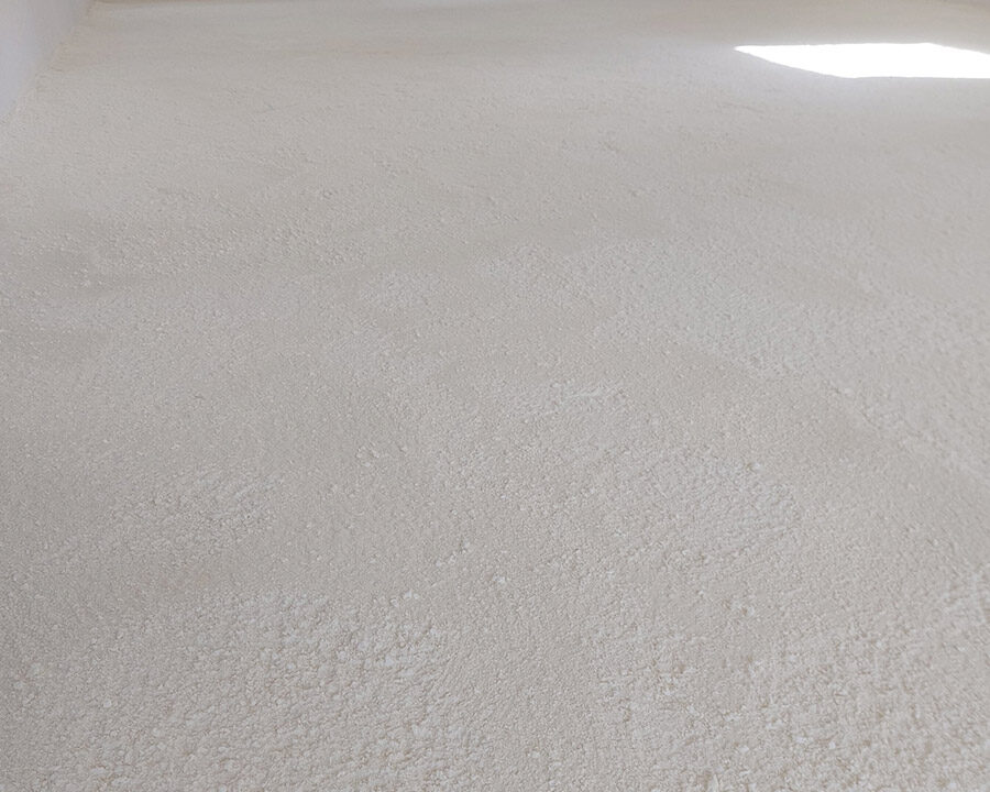 Isolation projetée au sol dans un bâtiment en construction