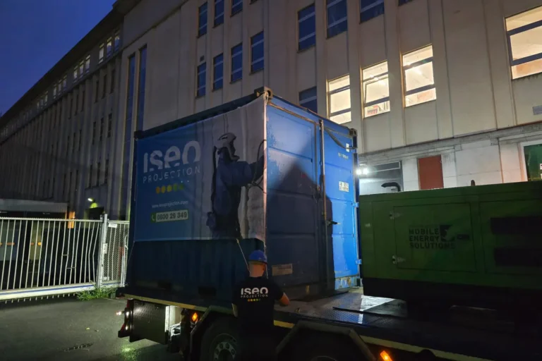 Déchargement de l’unité de projection ISEO dans un conteneur pour le chantier d’isolation de la toiture à Forest, en raison des contraintes d’accès au bâtiment.