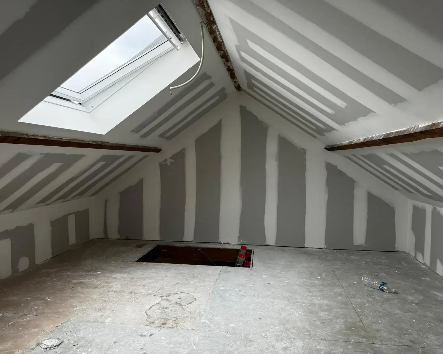 Isolation de toiture et travaux de parachèvement dans une habitation à Seilles avec projection de mousse ICYNENE Lite+ pour une rénovation énergétique complète.