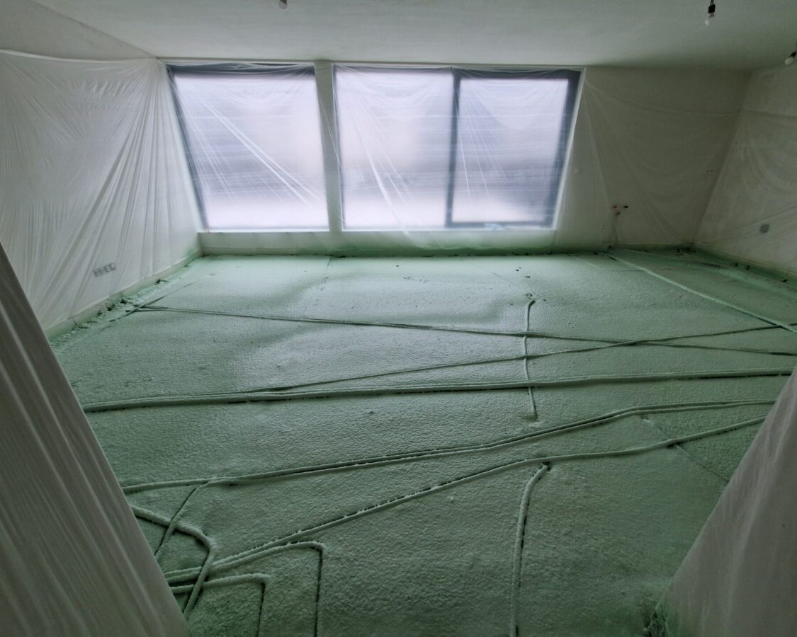 Isolation d'un sol par mousse projetée avec installation d'un chauffage par le sol