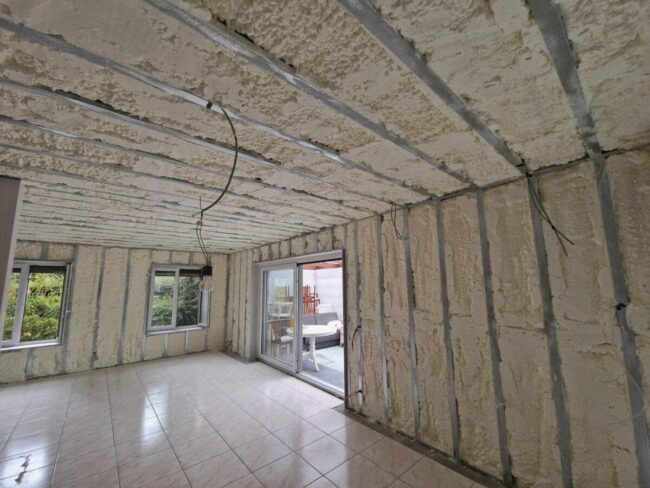 Murs et plafond du living d'une maison isolés avec de la mousse polyuréthane