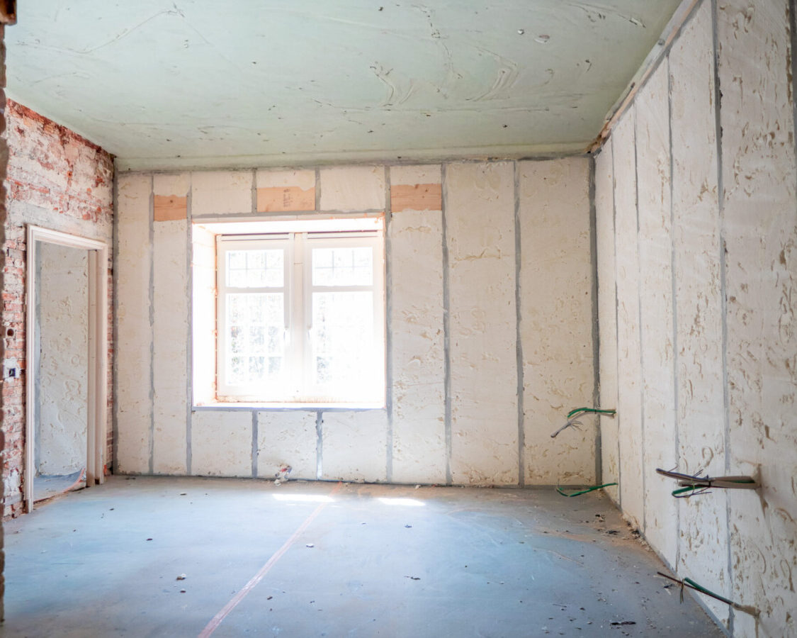 Grande pièce rénovée avec isolation intérieure des murs par mousse polyuréthane à cellules ouvertes, préservant la respiration des murs anciens.